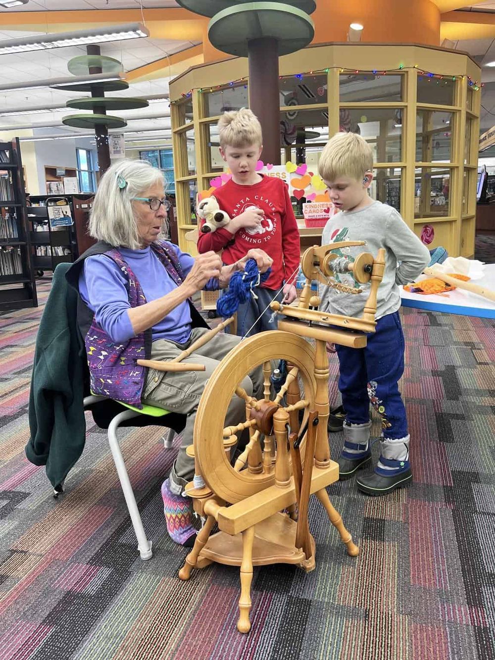 Handloom weaving demonstration at Quest for Directions event with children and an instructor.