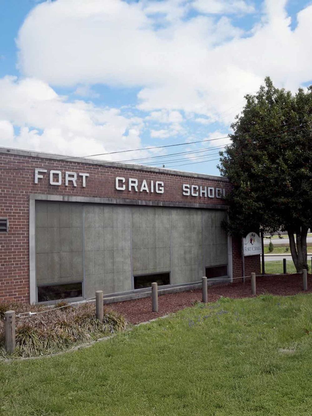 Fort Craig School building with brick exterior and surrounding greenery.