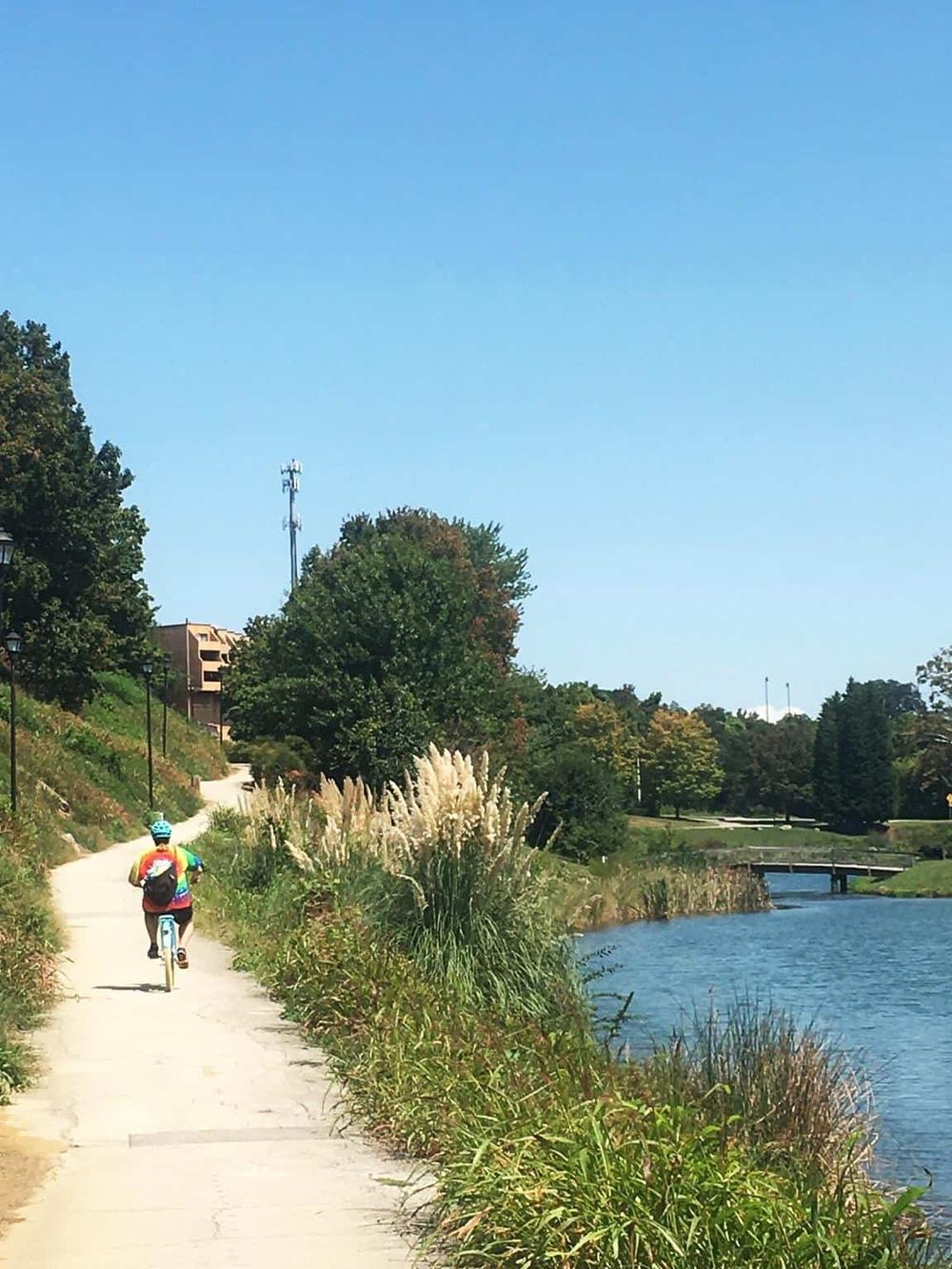 Bike riding along river trail for outdoor adventure and scenic views.