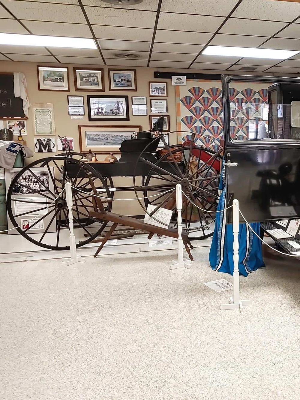 Vintage horse-drawn carriage exhibit at Quest for Directions museum showcasing local history and transportation.