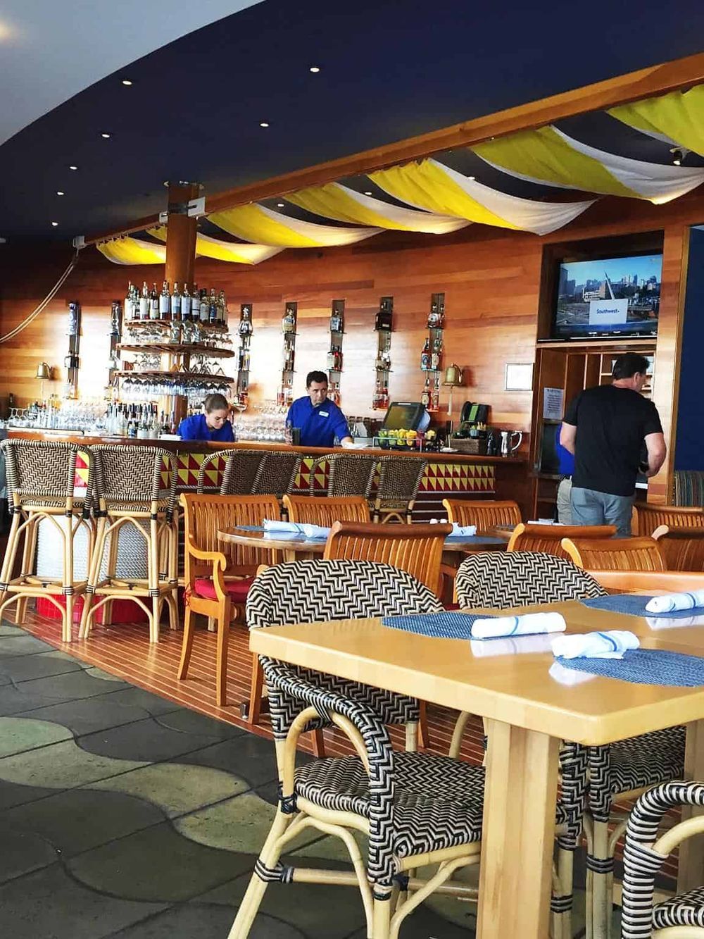 Cozy indoor bar and restaurant with wooden decor, modern furniture, and a vibrant atmosphere at QuestForDirections.