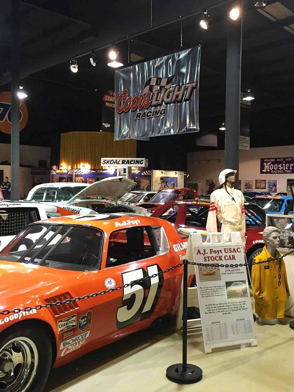 Vintage race car display at QuestForDirections with racing memorabilia and classic cars.