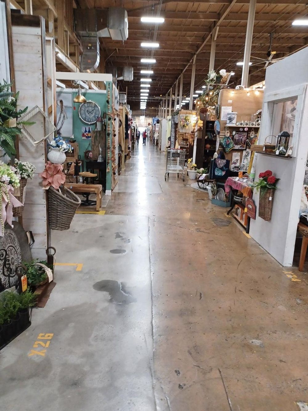 Vast indoor marketplace with various home decor shops and vintage items, ideal for shopping and browsing eclectic furniture and accessories.