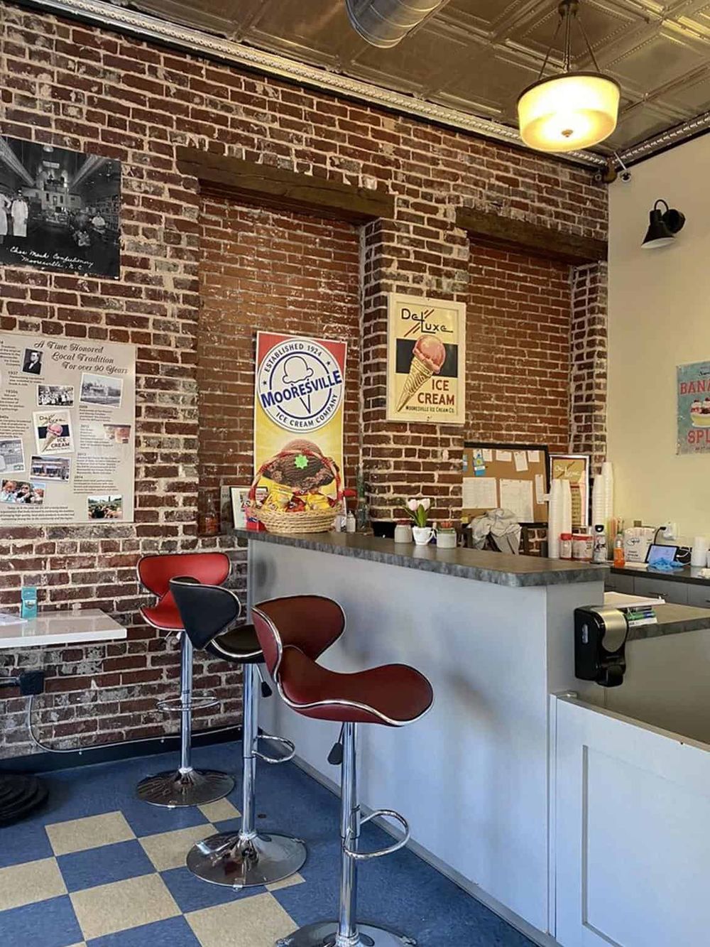 Cozy ice cream shop with exposed brick walls, modern bar stools, and vintage decor, perfect for dessert lovers.