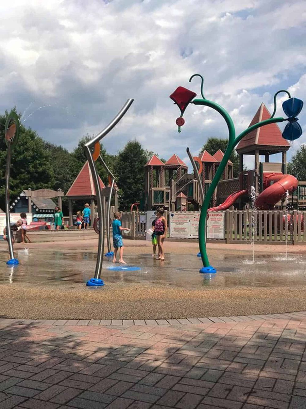 Colorful outdoor splash pad with fun water features at a family-friendly park.