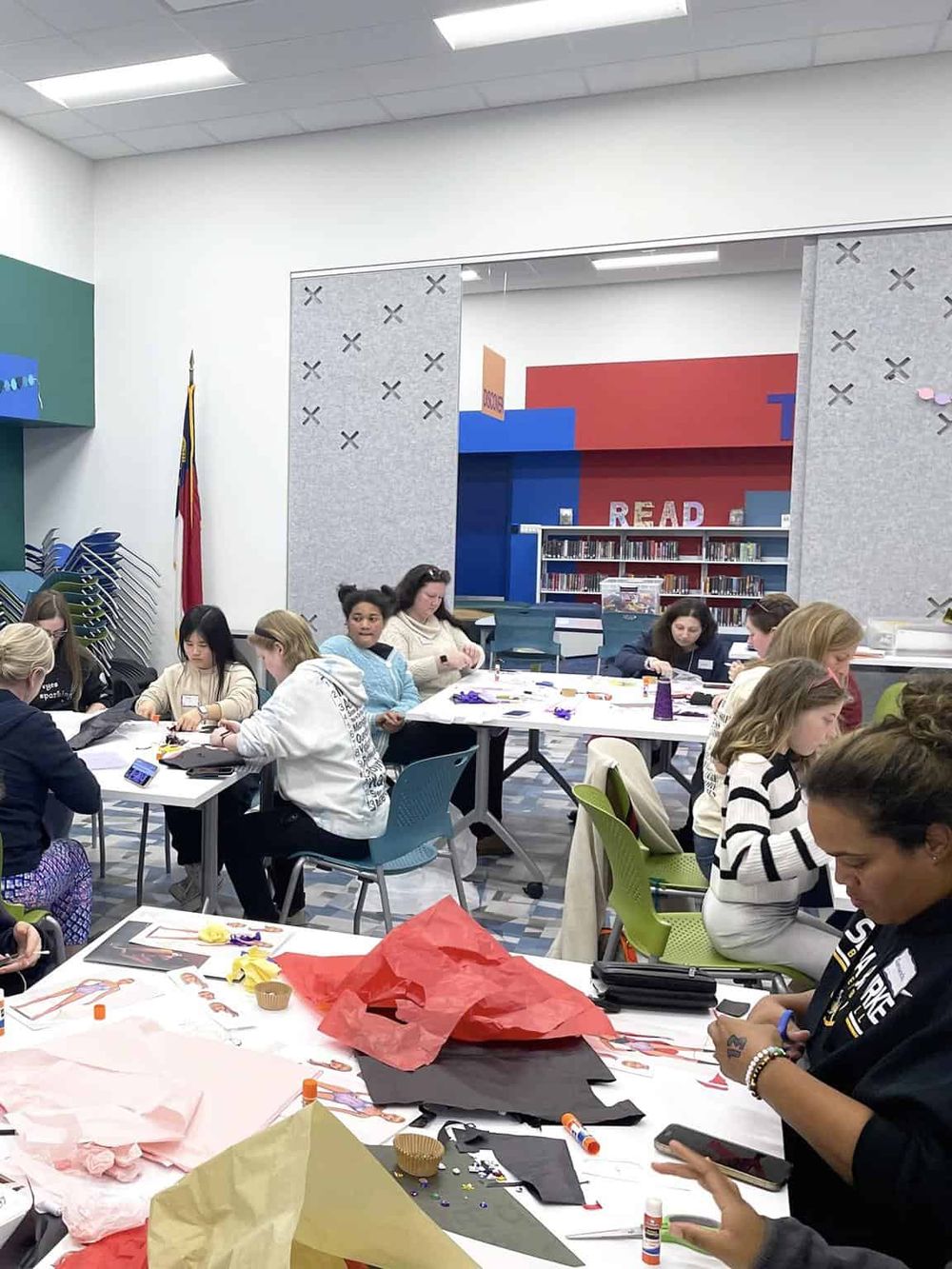 Children participating in a creative arts and crafts activity at a library or community center.