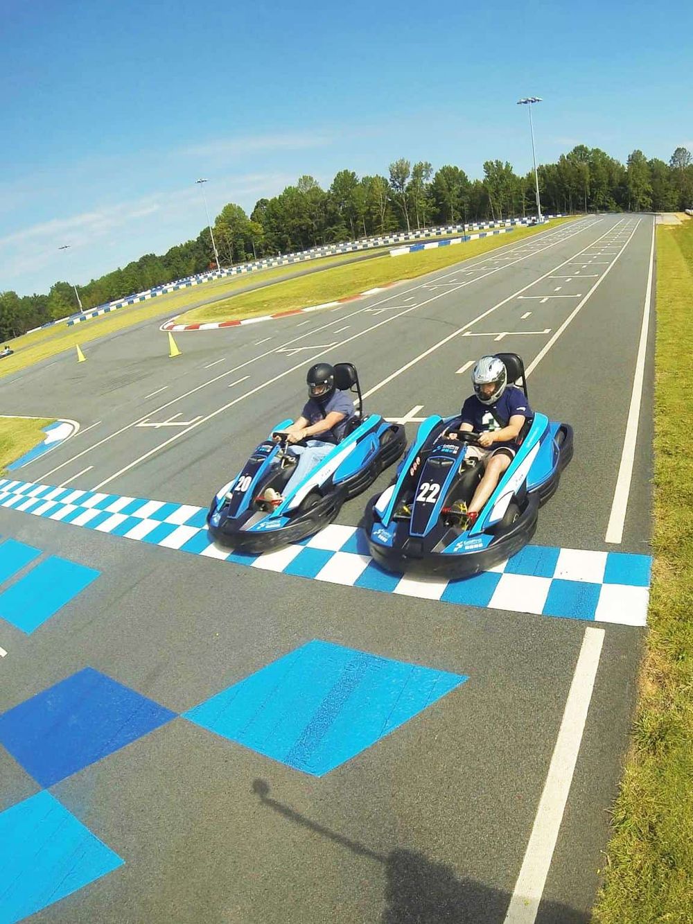 1. Go-kart racing at Quest For Directions, outdoor track with safety gear.