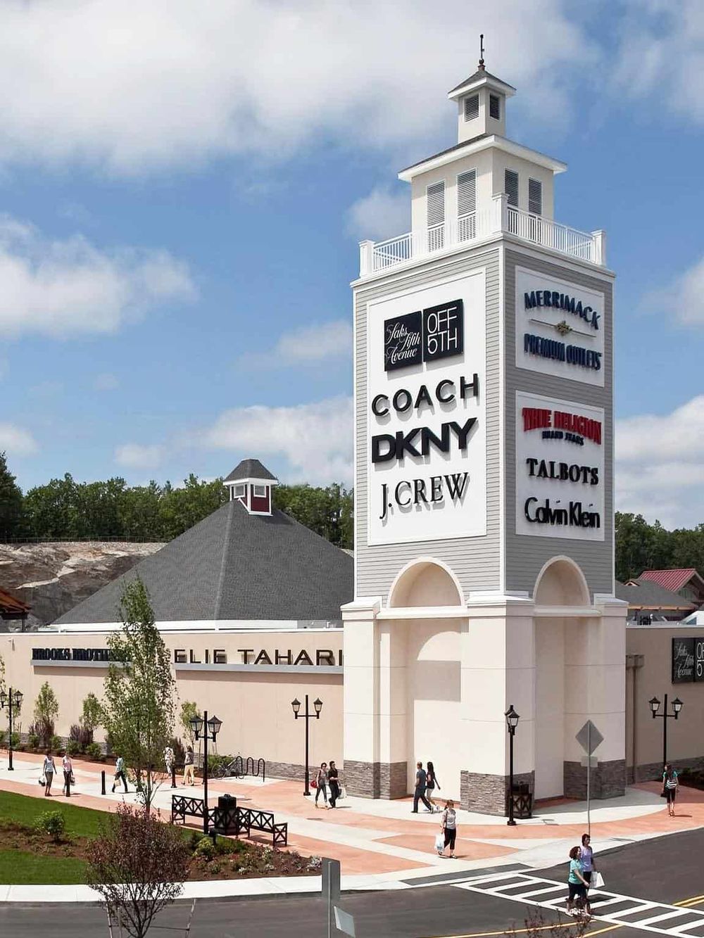 Vibrant shopping mall entrance showcasing popular retail stores and brand signage, ideal for fashion shopping and retail therapy.