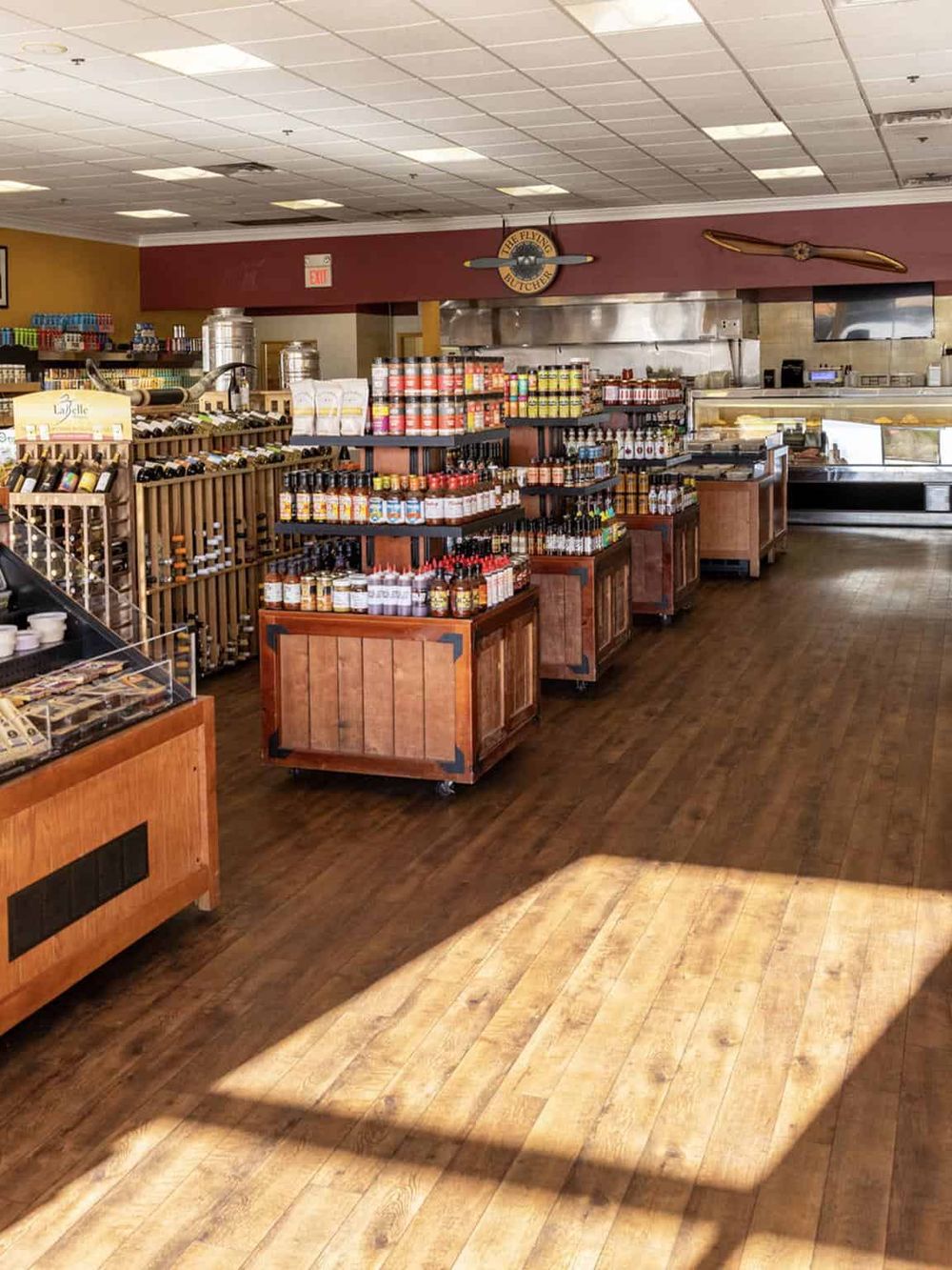 Aisle of gourmet sauces and condiments inside a specialty food store.