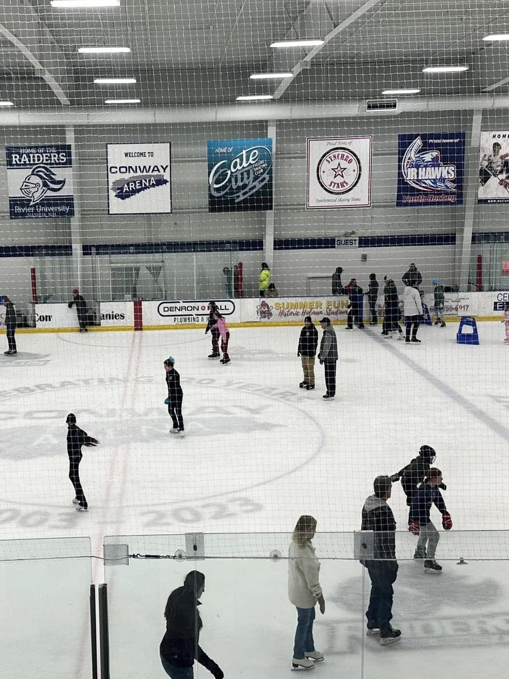 Ice skating rink with people enjoying skating and ice sports at QuestForDirections.