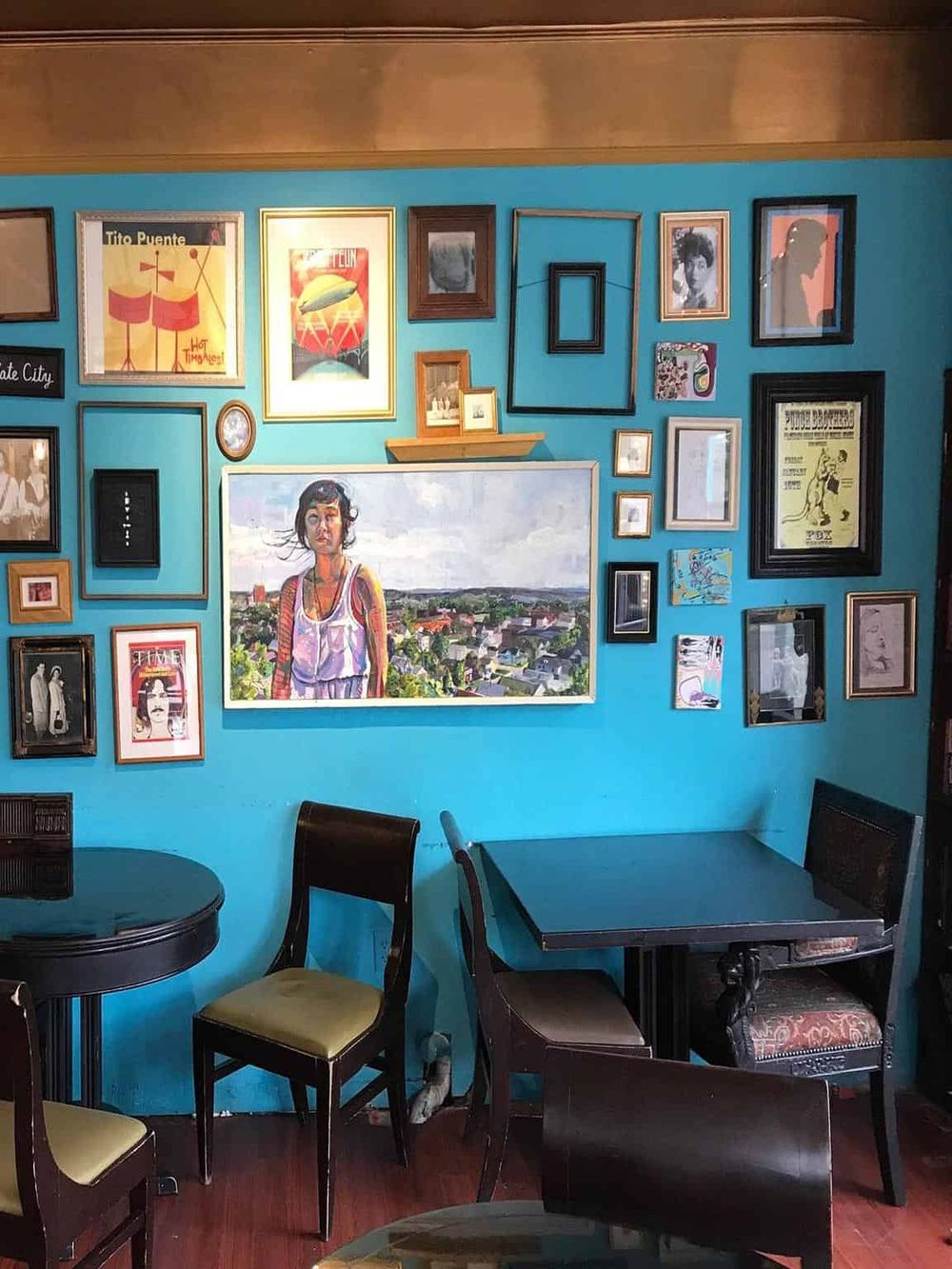 Colorful wall with eclectic art gallery at Quests for Directions café or restaurant.