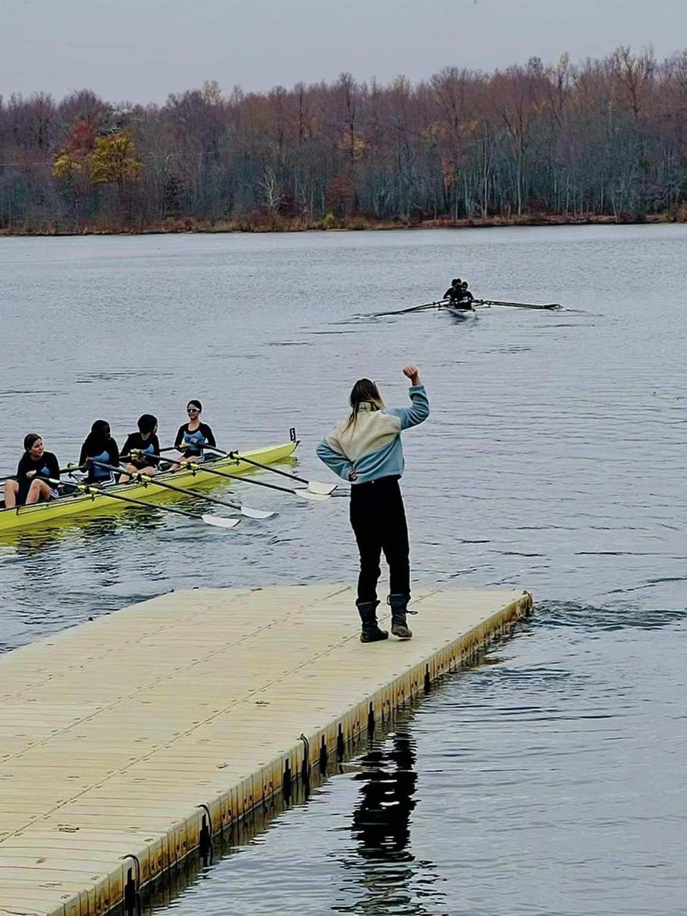 1. Group rowing team preparing on a dock at QuestForDirections lakeside.