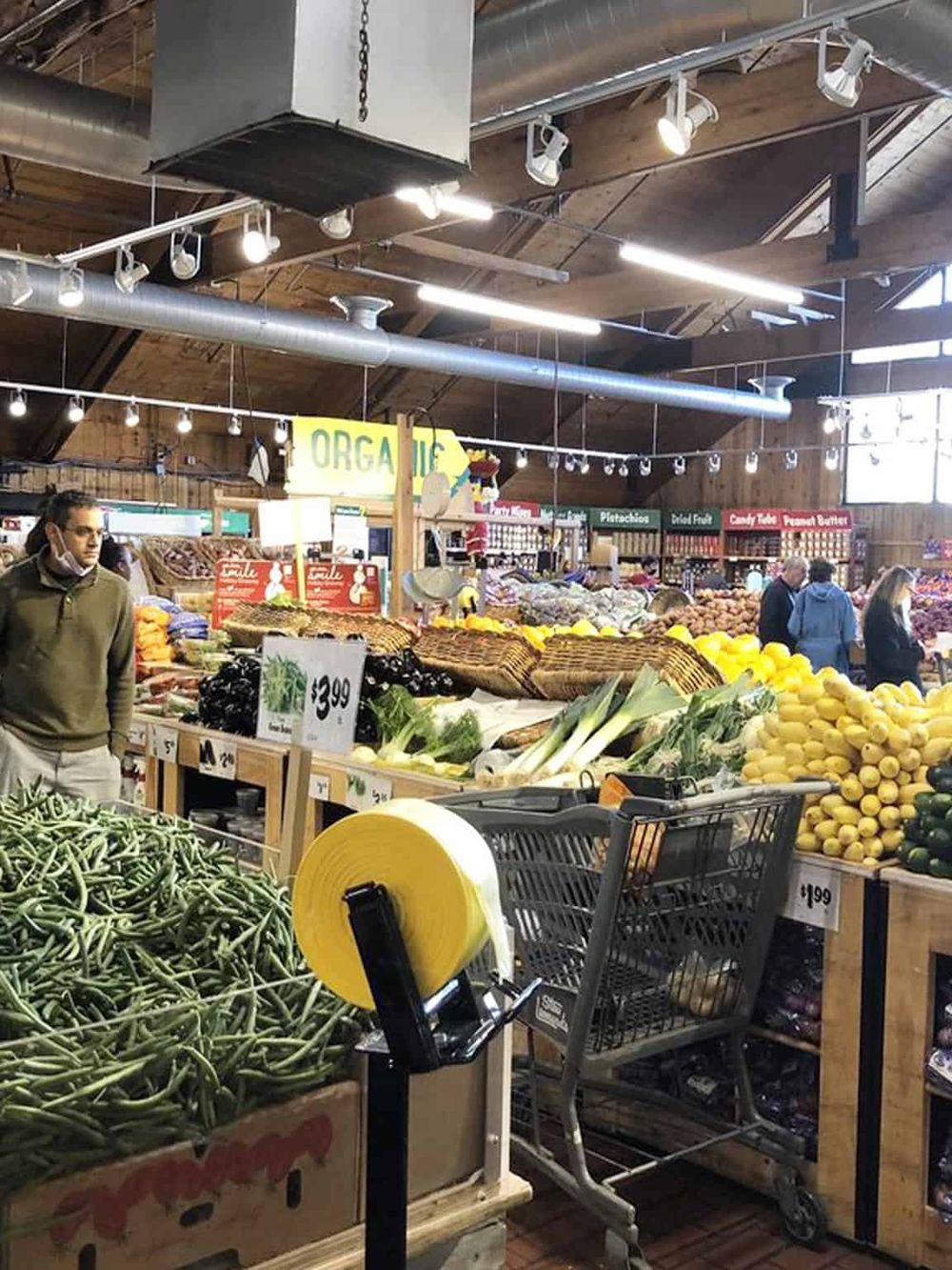 Fresh organic produce shopping at QuestForDirections grocery store. Wide selection of vegetables and fruits in a bright, inviting market setting.