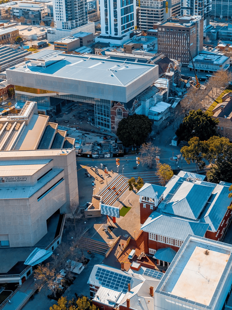 Modern cityscape with Quest For Directions facility and surrounding buildings and streets.