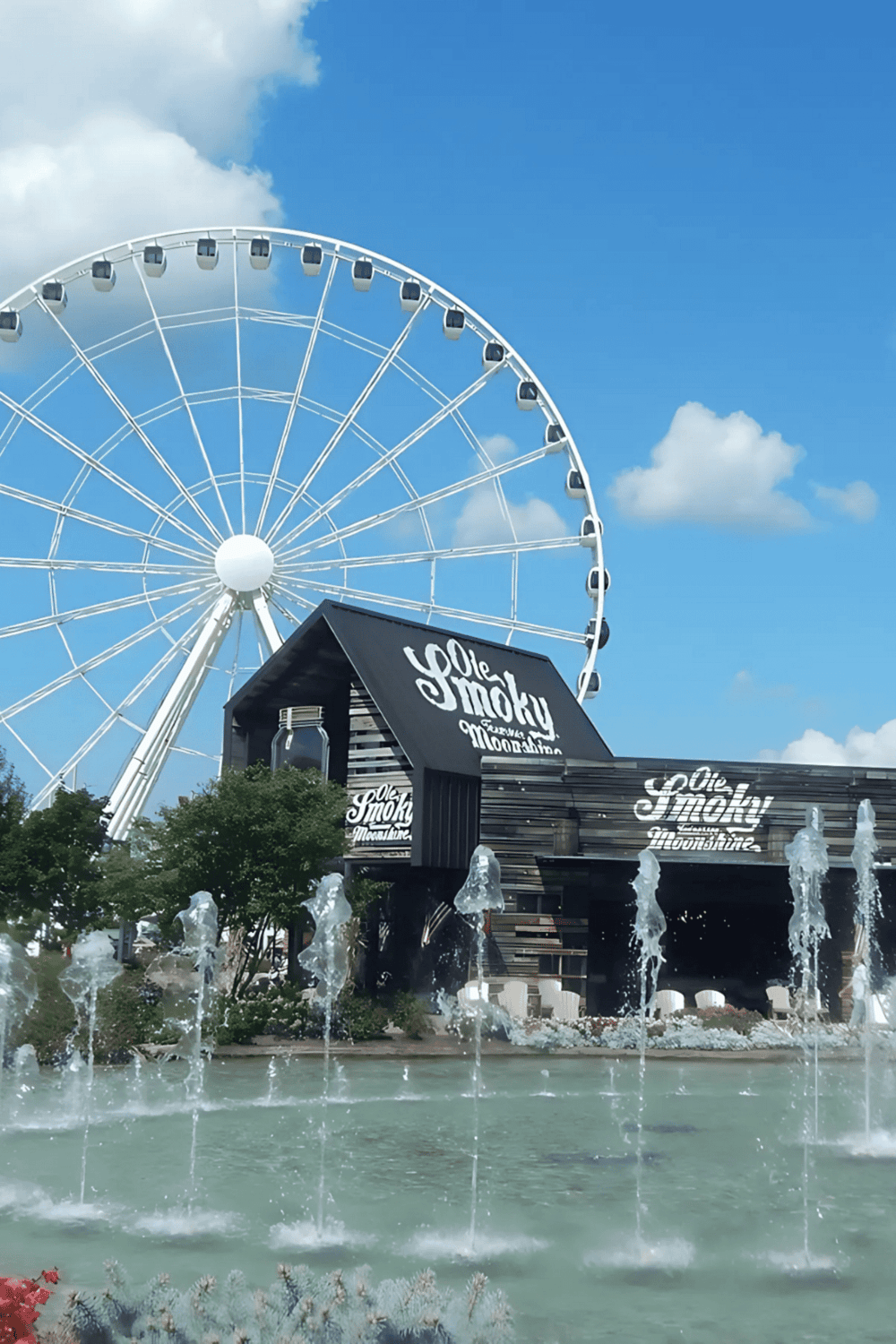 Ferris wheel and funnel cake stand at outdoor amusement park, perfect for family fun and directions.