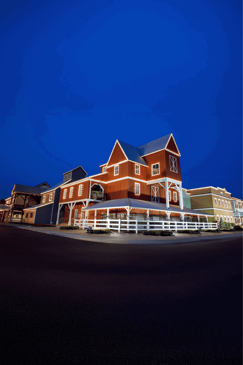 Colorful rustic barn-style building with modern design elements at dusk.