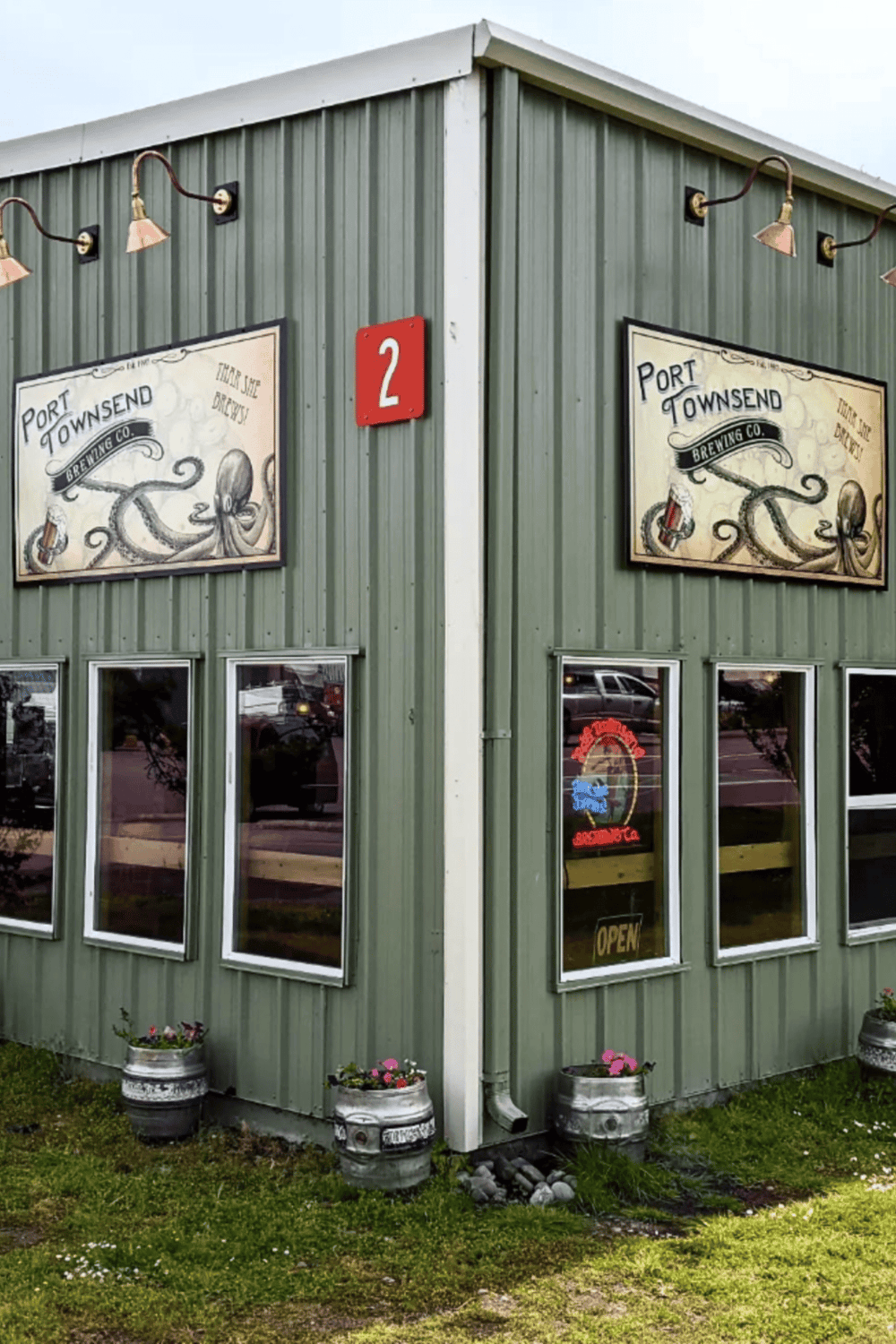 Octopus brewing company sign on a green exterior building with brewing-related artwork.