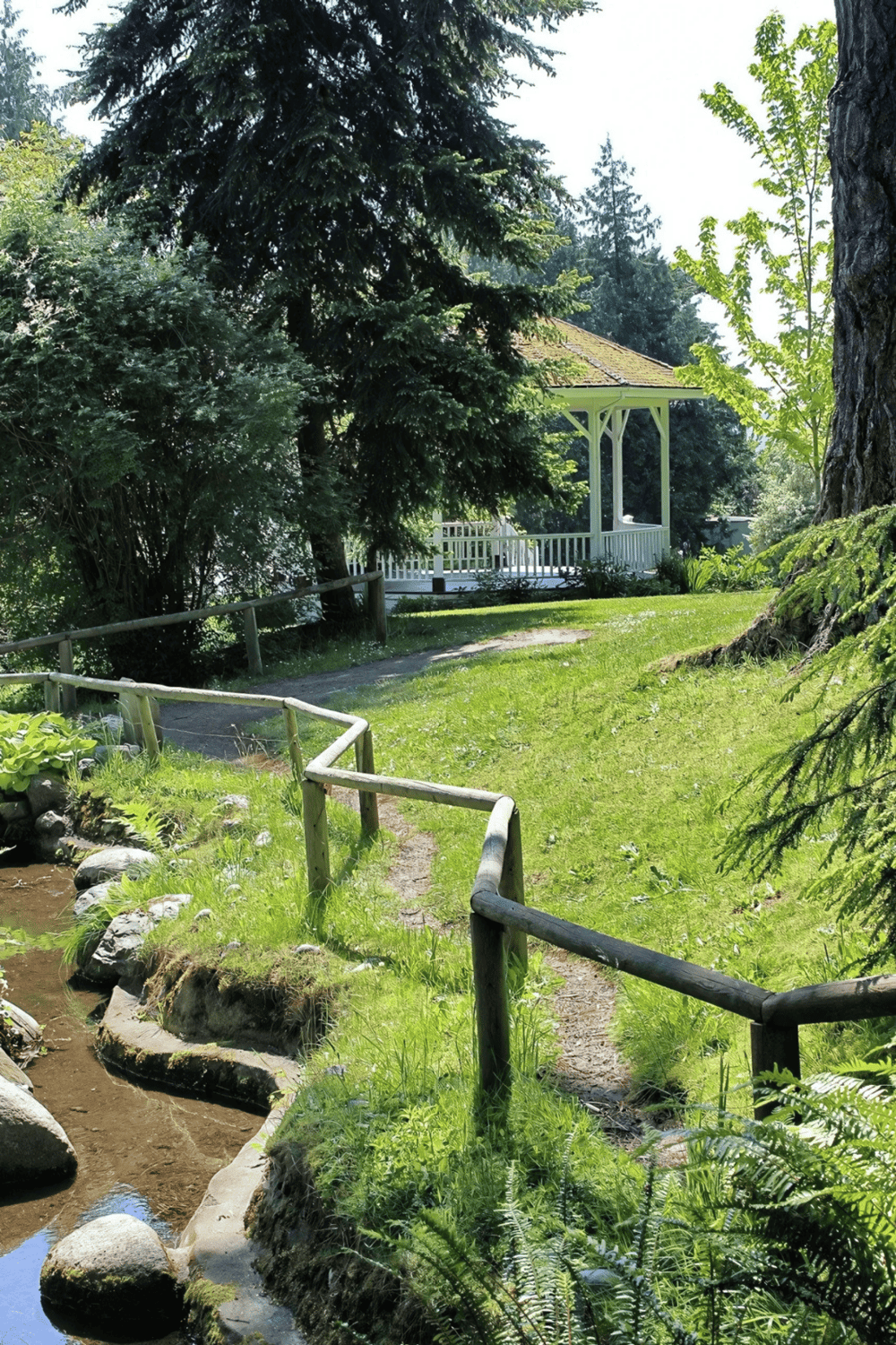 Tranquil garden with a gazebo, surrounded by lush trees and greenery, perfect for peaceful outdoor visits.