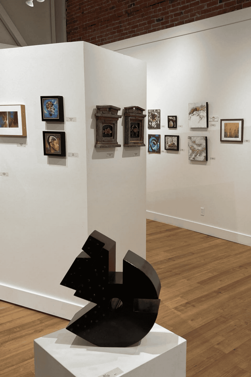 Vibrant art gallery showcasing diverse paintings and sculpture at QuestForDirections museum.
