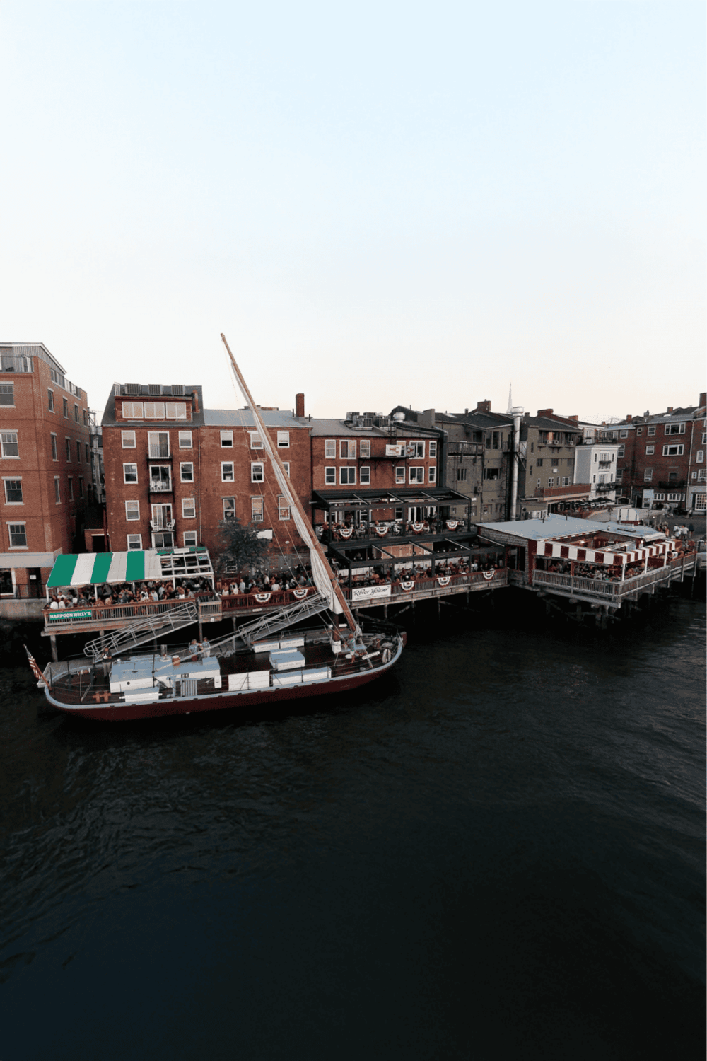 Harbor boat dockside at QuestForDirections, scenic waterfront dining and transportation hub.