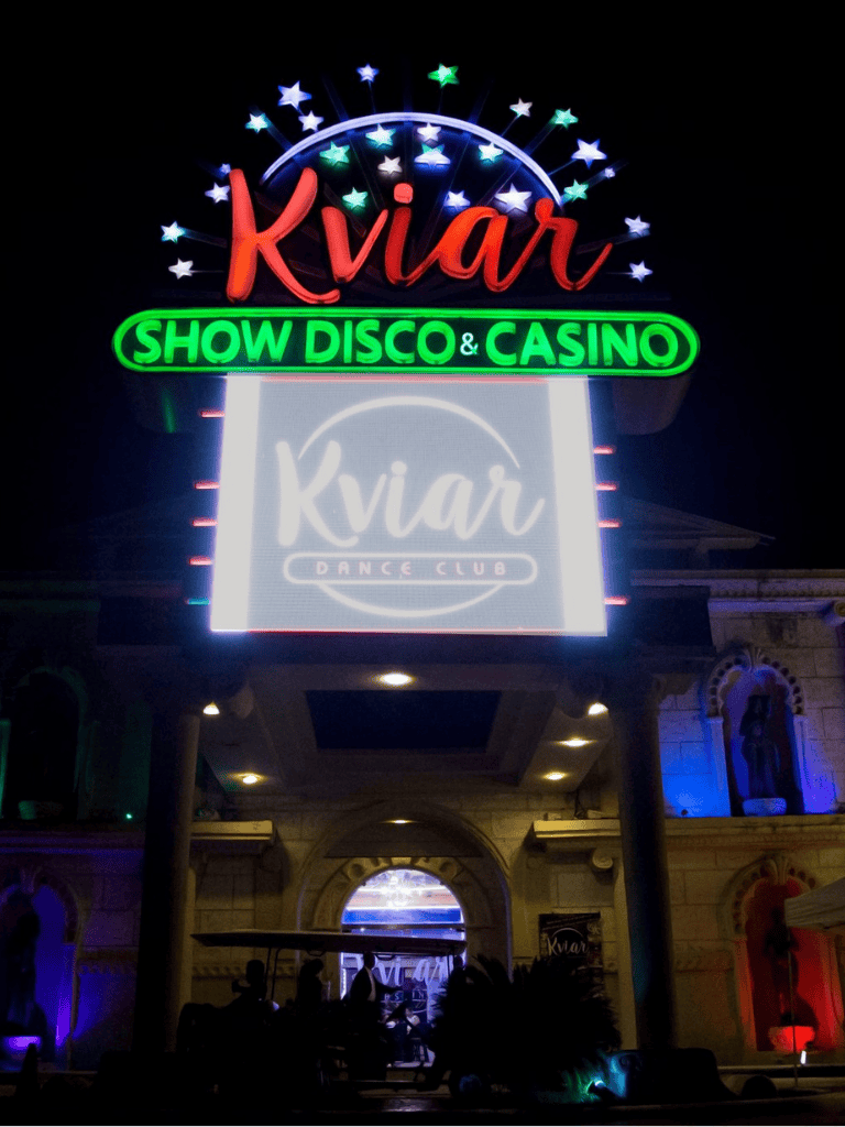 Kviar Show Disco & Casino neon sign at night, vibrant nightlife entertainment venue.