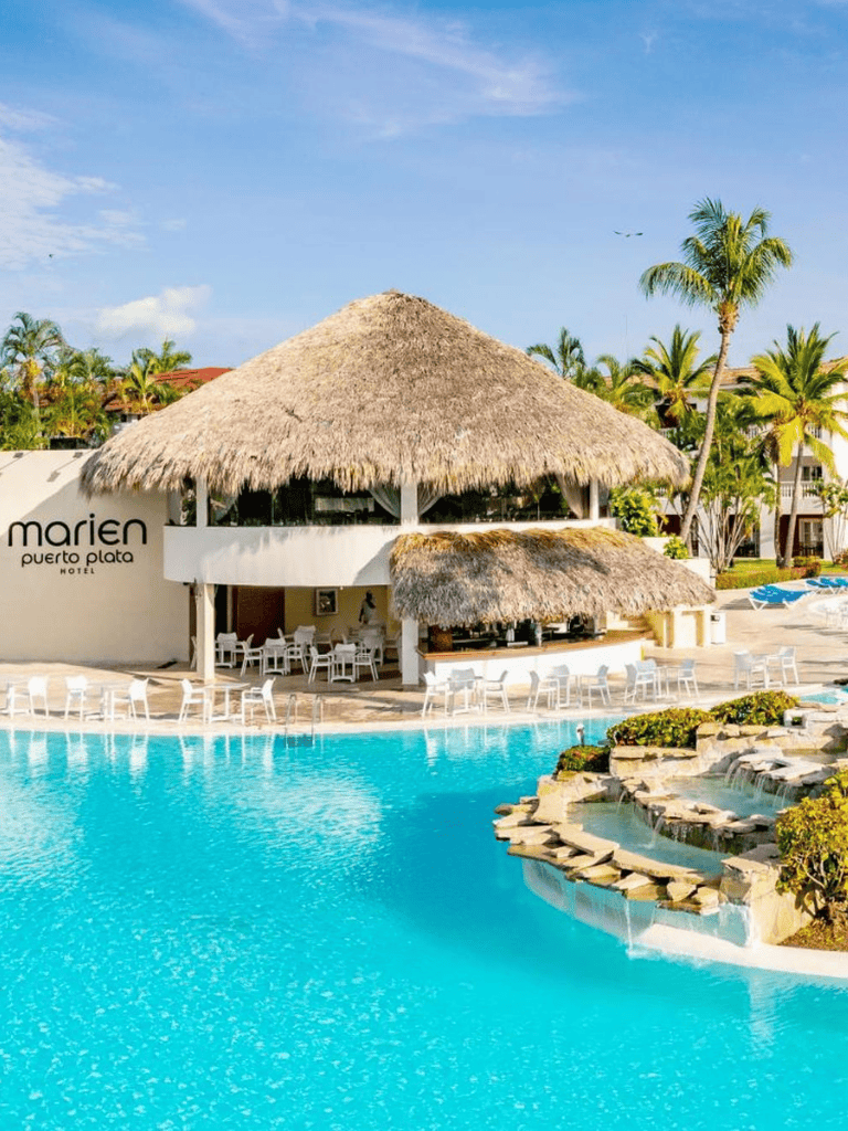 A tropical poolside resort with thatched roofs, palm trees, and a relaxing atmosphere in Puerto Plata.