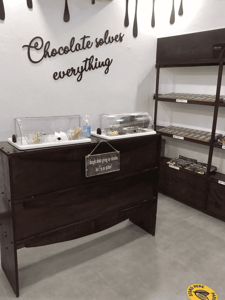 Chocolate tasting station with signage "Chocolate solves everything" at QuestForDirections.