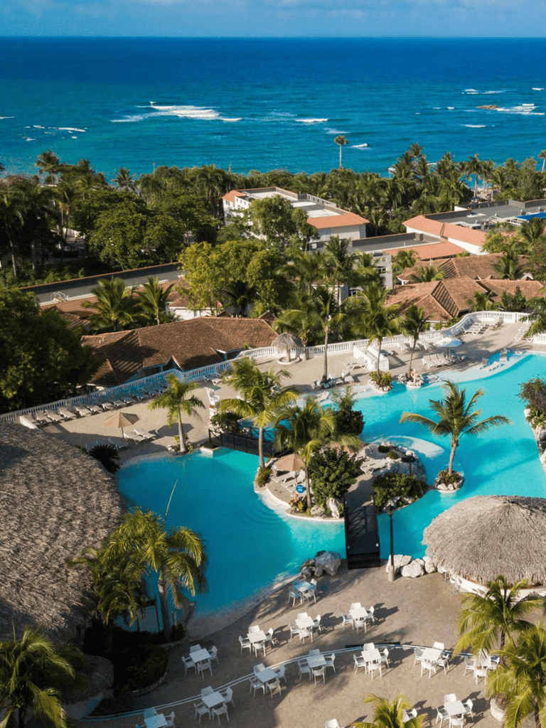 Luxurious resort pool with ocean view and tropical landscaping for relaxation and vacation stays.