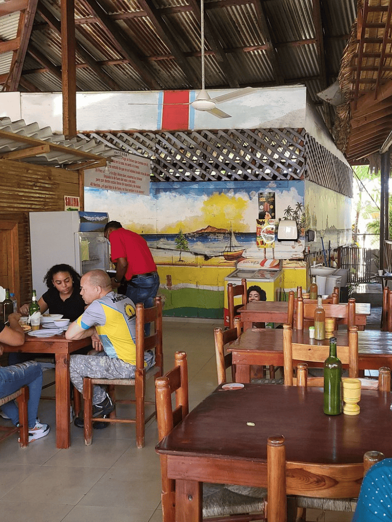 Beachside restaurant interior showcasing tropical décor and local cuisine dining experience.