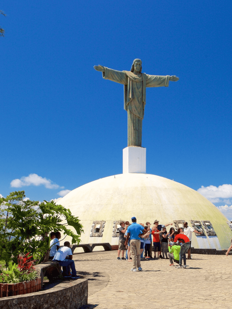 Statue of Christ the Redeemer in Rio de Janeiro, Brazil, with tourists visiting.