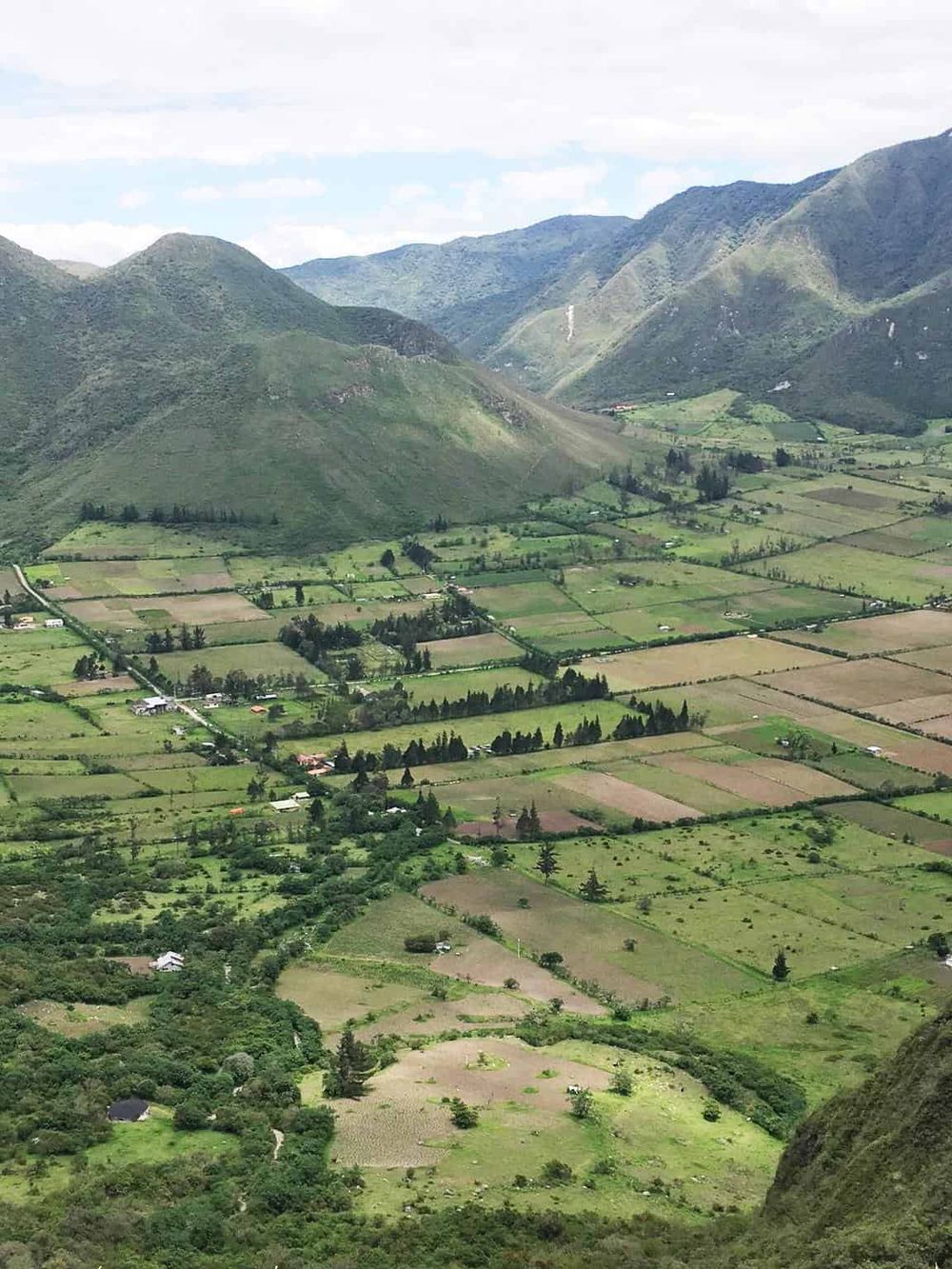 Lush green valley and rolling mountains in scenic rural landscape, perfect for travel and exploration.