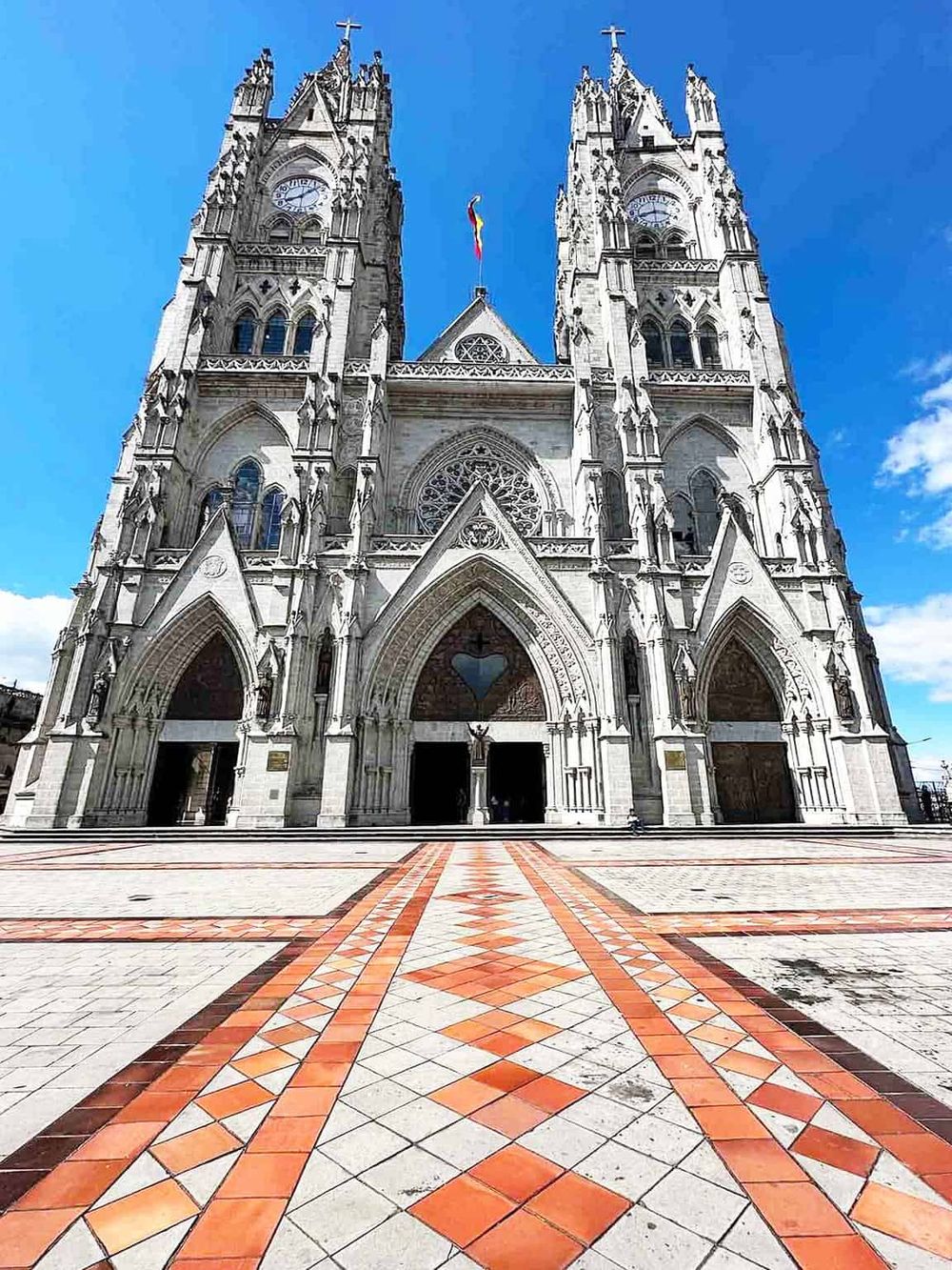 Majestic Gothic cathedral with twin towers against blue sky, iconic religious architecture.