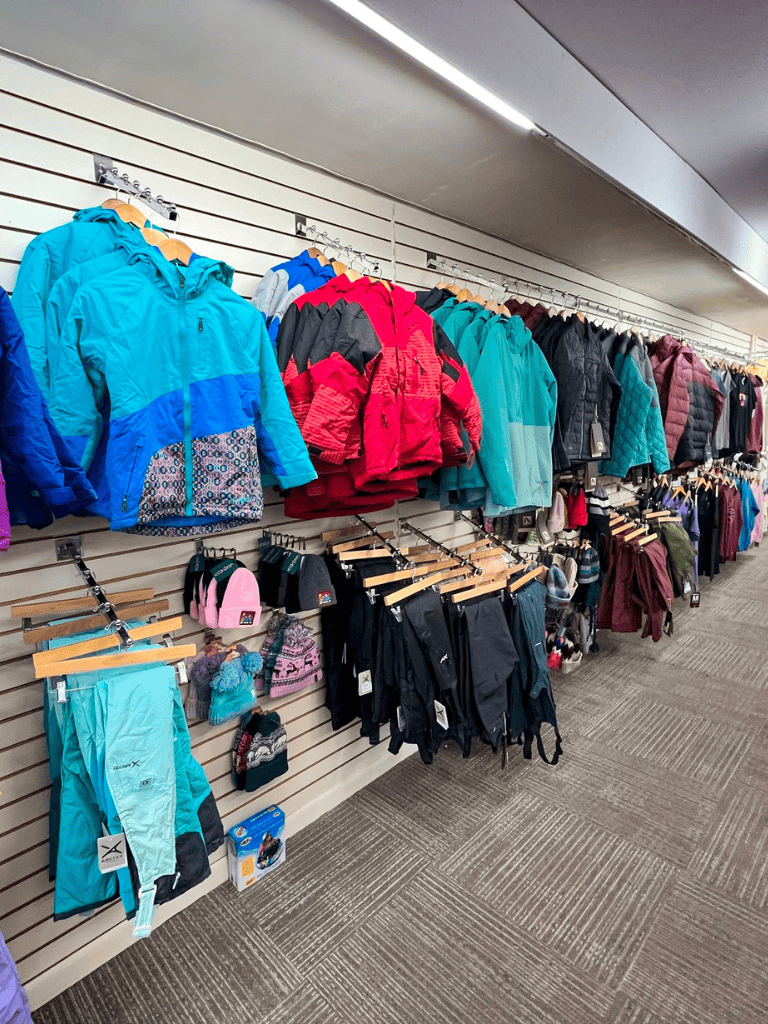 Warm outdoor jackets and hiking gear in a retail store for adventure and travel ready.
