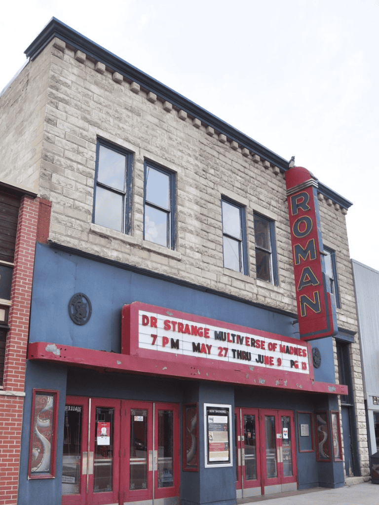 1. Historic Roman theater building showcasing classic architecture and signage.