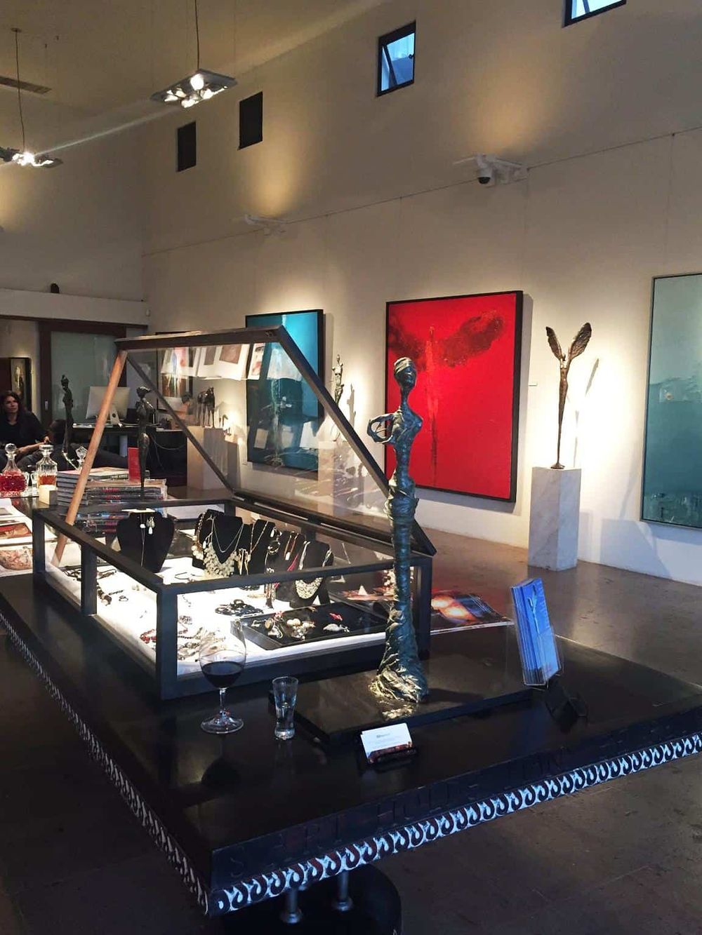 Elegant art gallery showcasing contemporary sculptures and paintings, perfect for art enthusiasts and collectors.