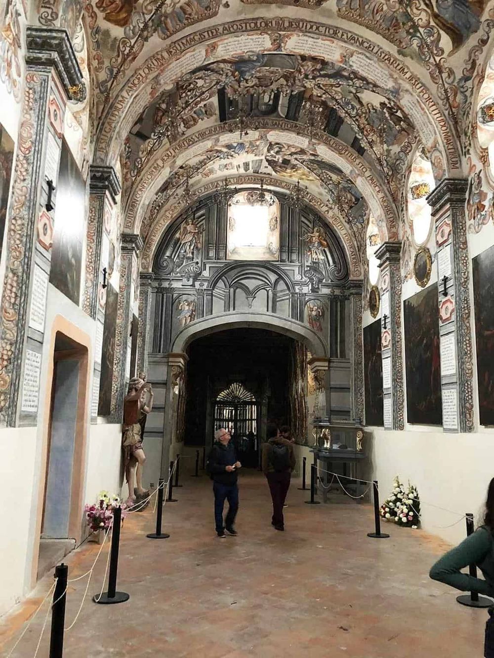Vibrant church interior with ornate frescoes, religious sculptures, and historical artwork, showcasing art and architecture of the Renaissance era.