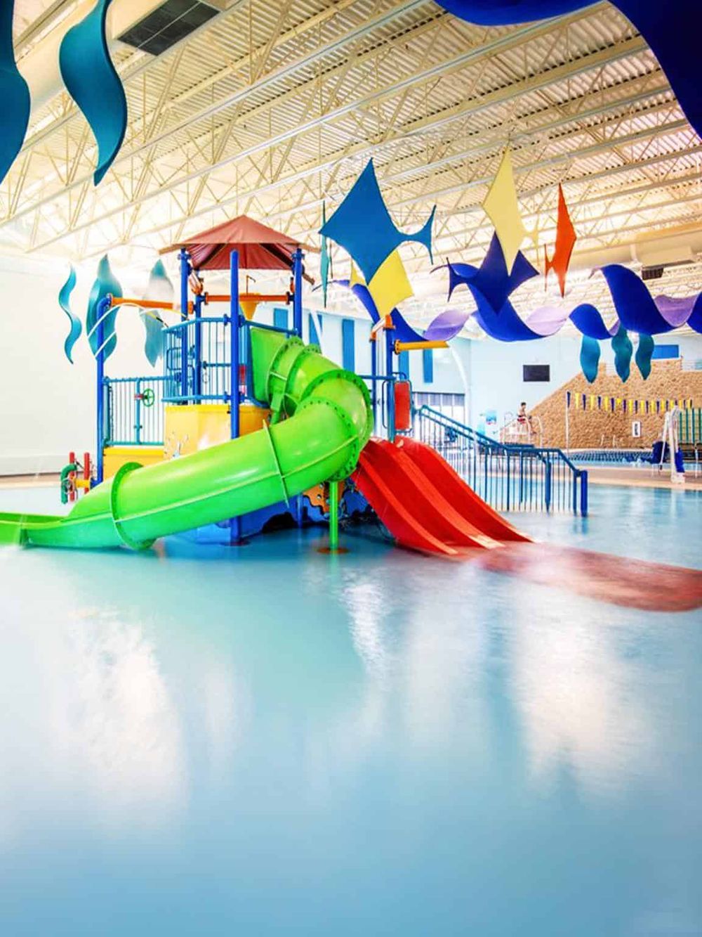 Colorful indoor water park with slides and wave pools for family fun.