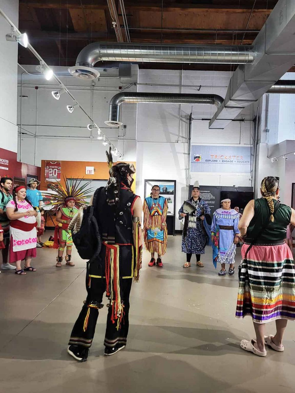 Colorful Indigenous cultural celebration at QuestForDirections exhibit, highlighting Native traditions and attire.