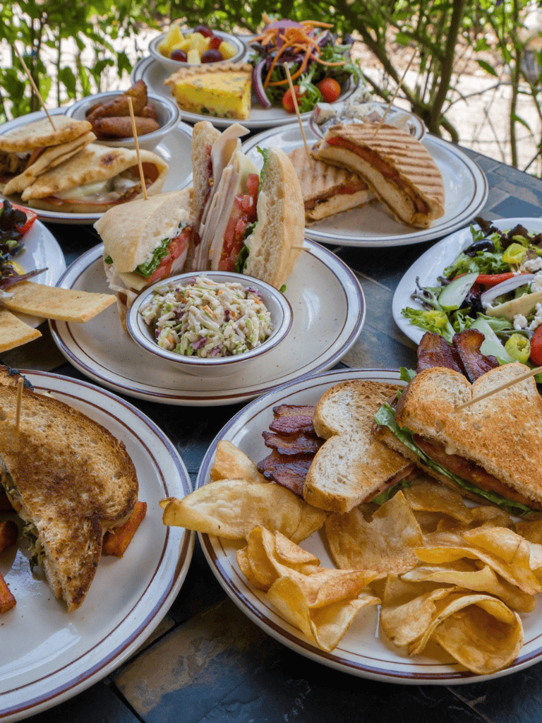 Savory and fresh assorted dishes including sandwiches, salads, and wraps for a satisfying meal.