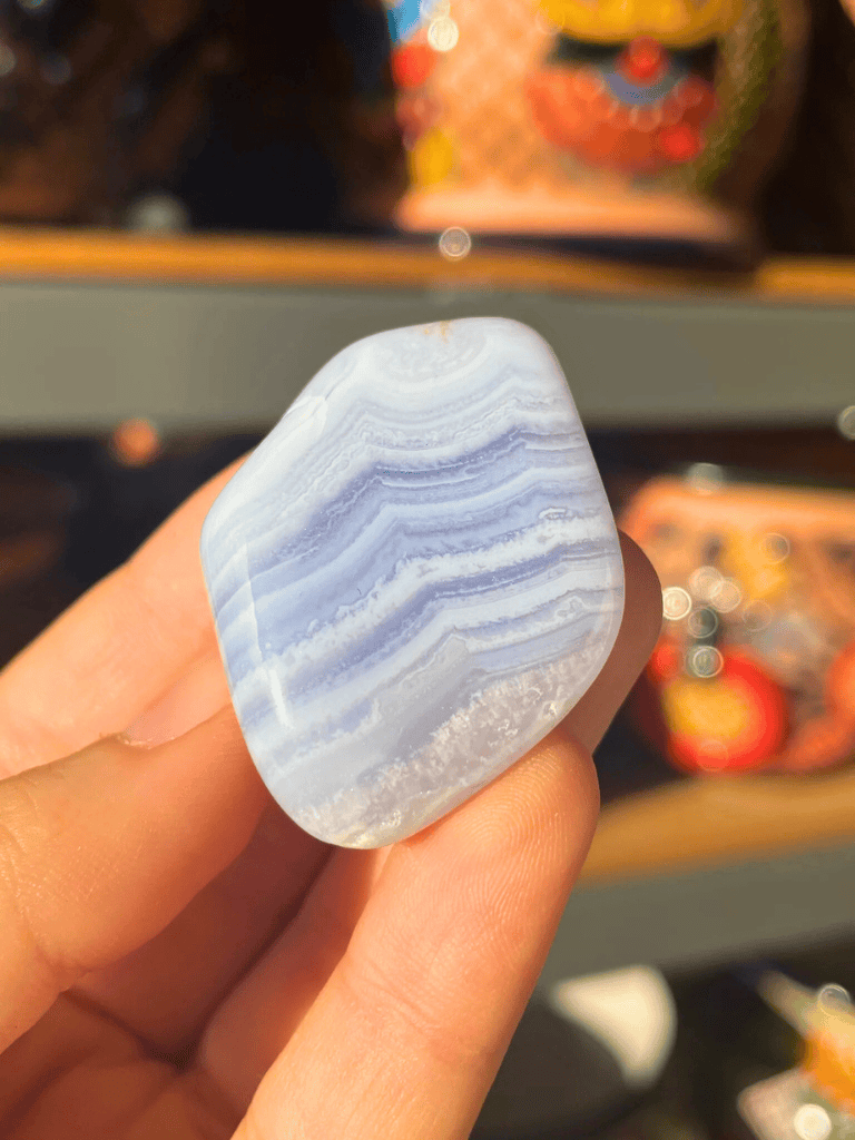 Blue banded agate mineral specimen, natural polished stone with vibrant blue and white layered bands.