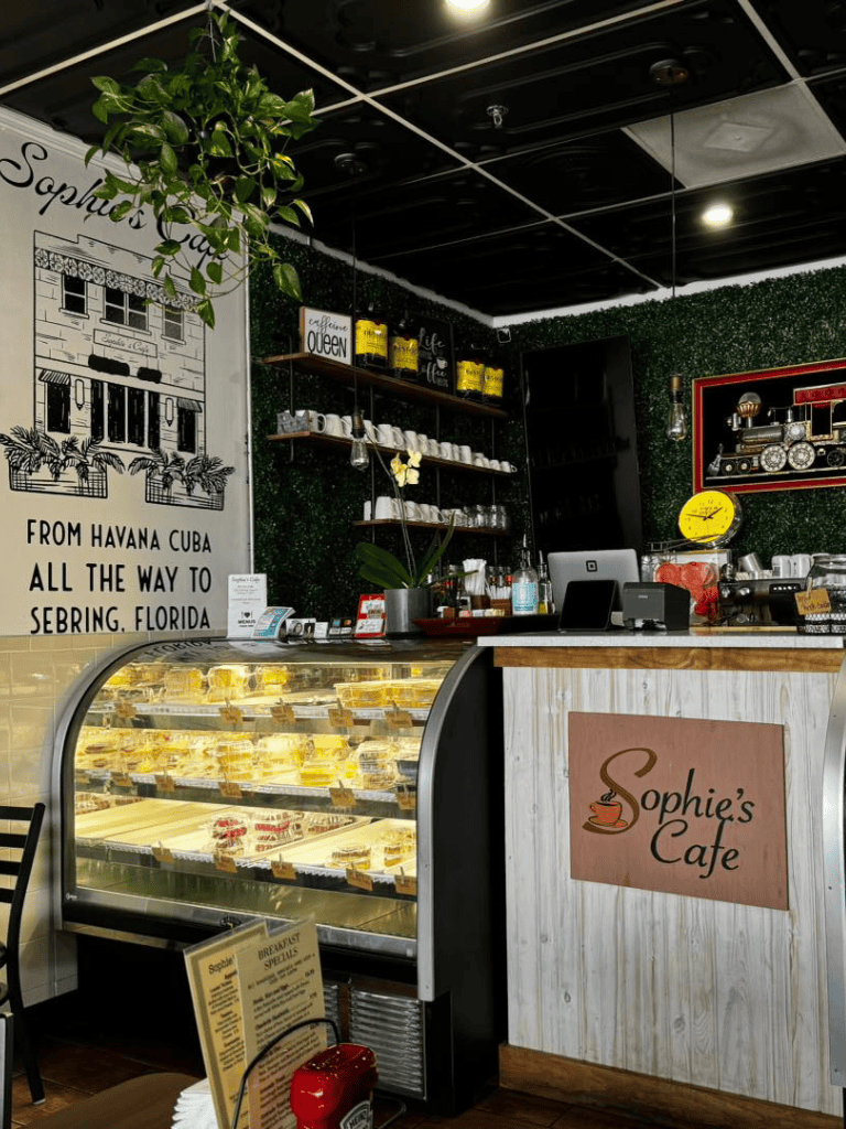 Fresh bakery display case with assorted desserts at Sophie’s Cafe in a cozy coffee shop setting.