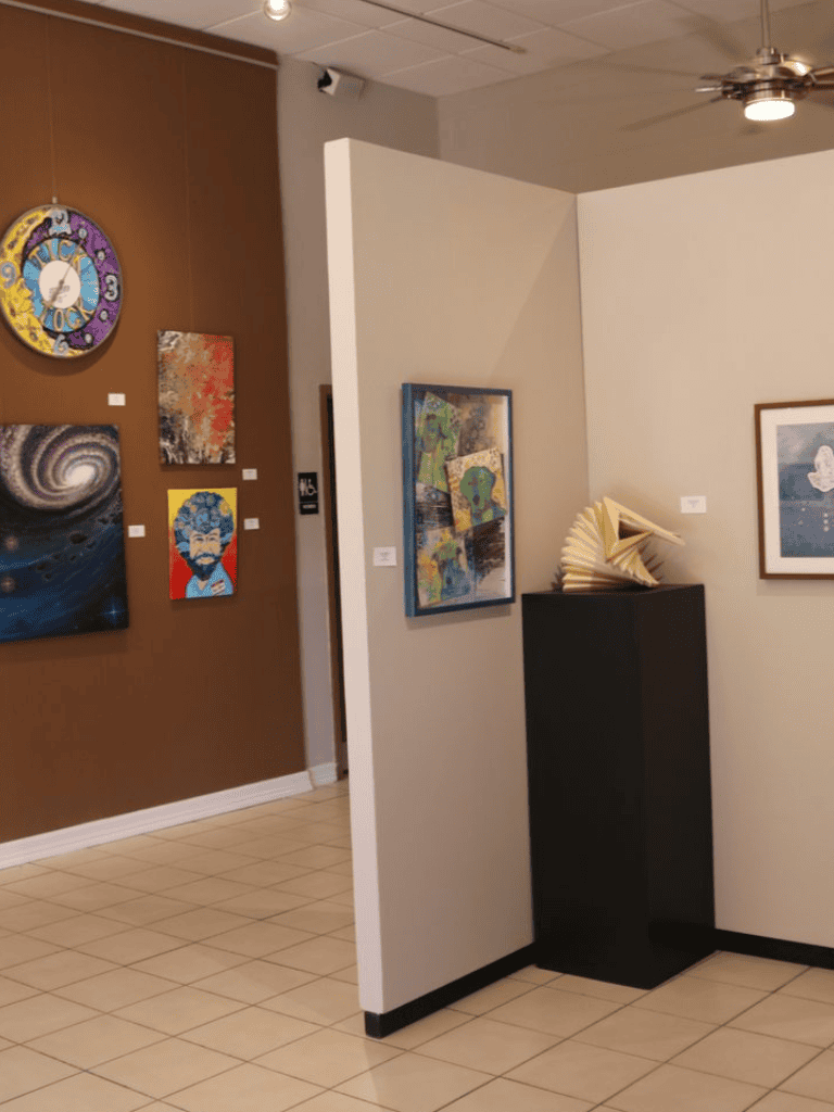 Colorful art gallery exhibit at QuestForDirections with paintings and sculptures.