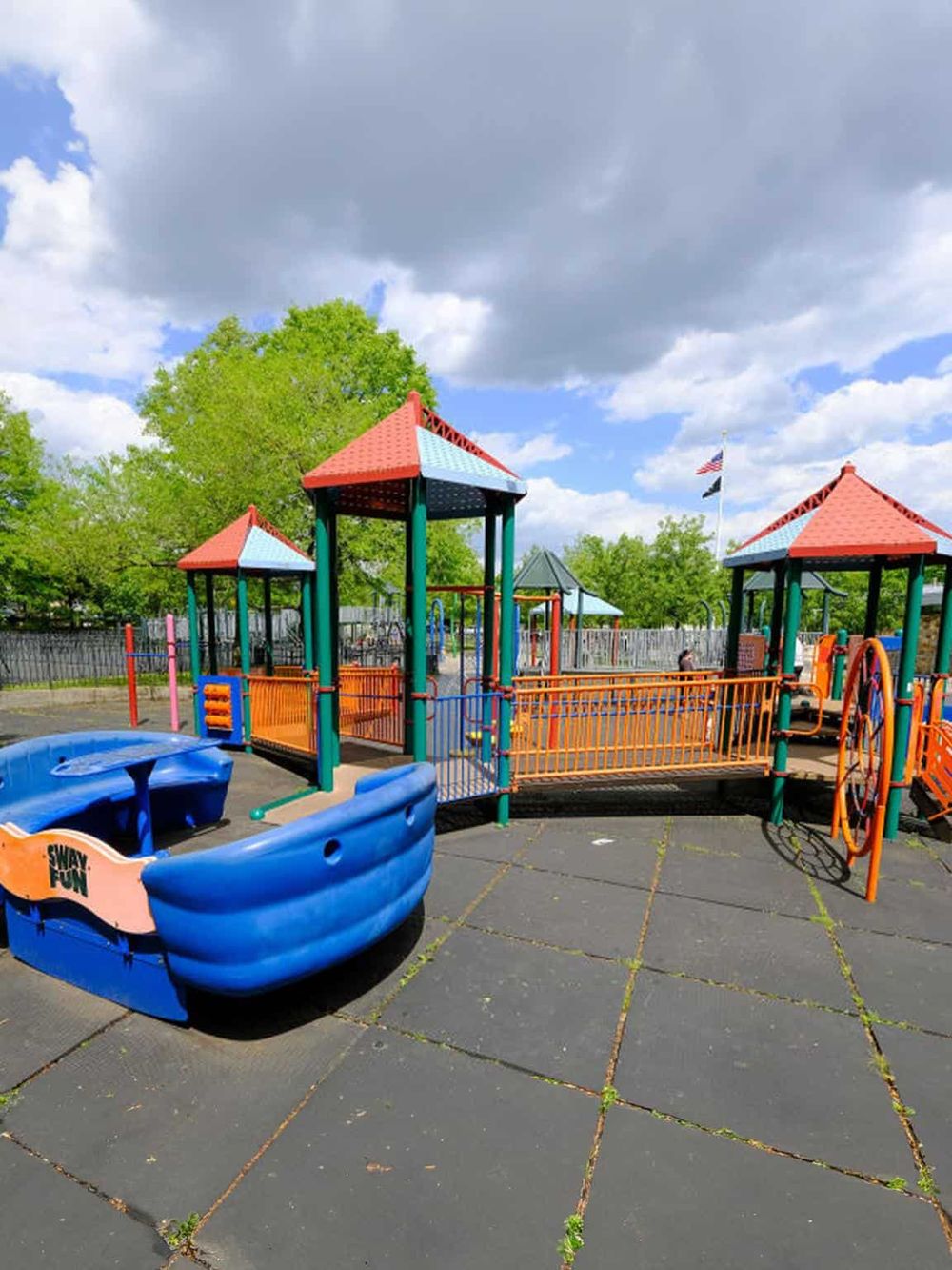 Colorful kids' playground at QuestForDirections with slides, bridges, and swing areas in vibrant colors.