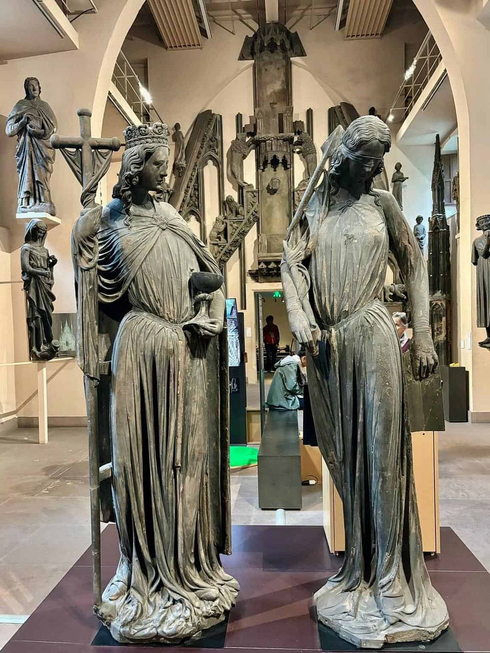 Ancient religious sculptures displayed in a museum, showcasing historical Christian artifacts and art.