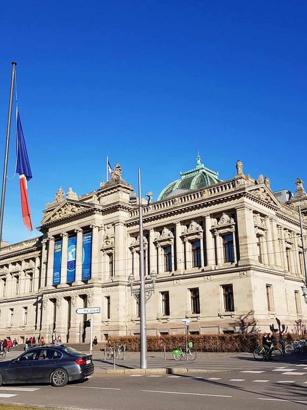 Grand historic building with classic architecture and a blue sky, highlighting QuestForDirections' navigation services.