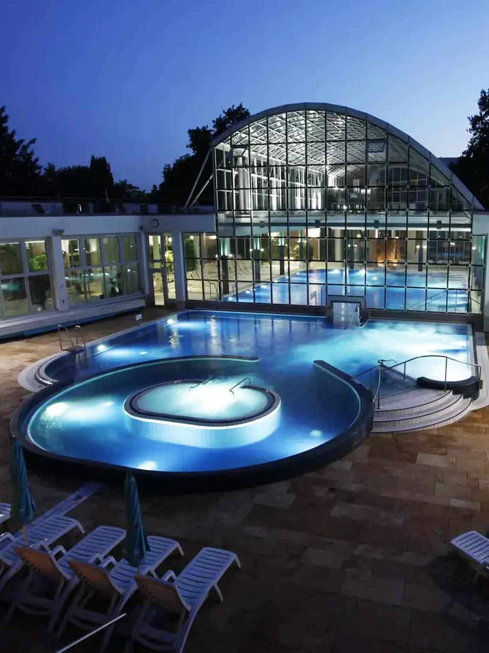Luxurious indoor outdoor heated spa and pool with glass conservatory at QuestForDirections.
