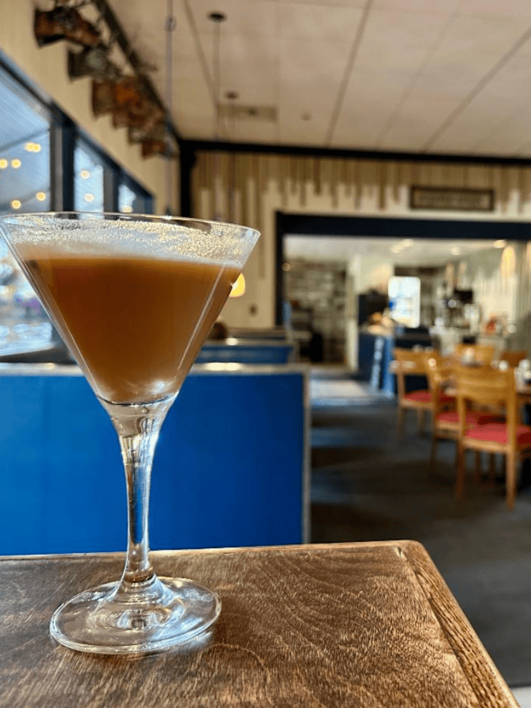 Rich coffee cocktail in a martini glass at QuestForDirections restaurant.