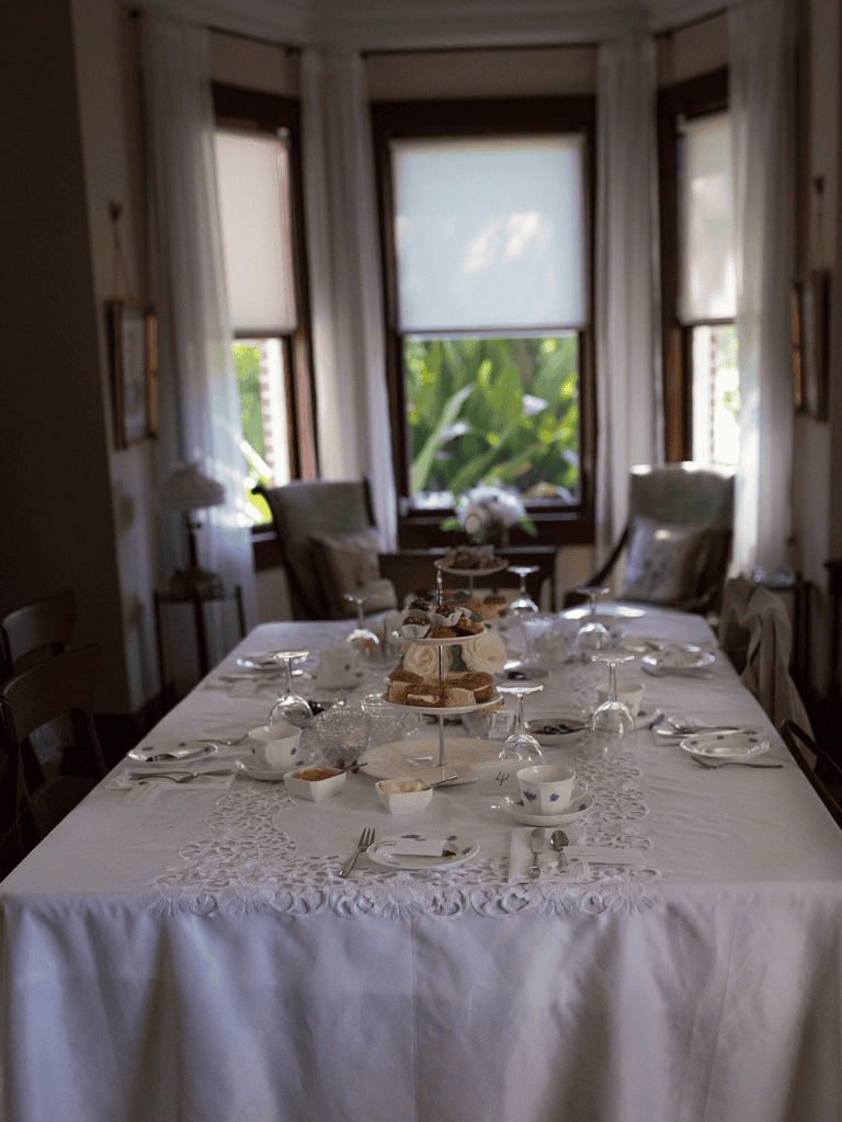 Cozy dining room with elegant table setting and natural light from large windows.