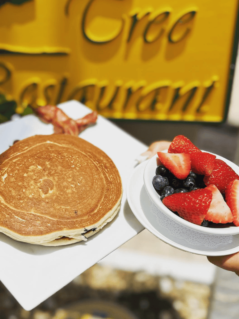 Golden brown pancake with fresh strawberries and blueberries for breakfast or brunch.
