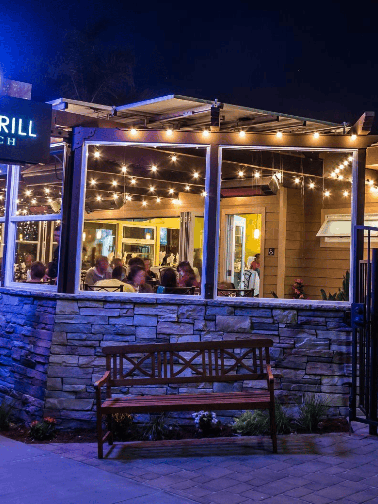 Cozy outdoor dining area with string lights at Quest for Directions restaurant.